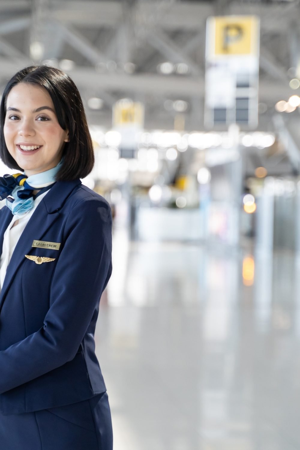 Portrait of Caucasian flight attendant standing in airport terminal.